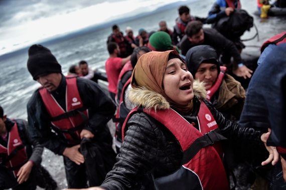 A woman cries as she scrambles ashore along with other refugees and migrants arriving on the Greek Island of Lesbos on October 24, 2015 after crossing the Aegean sea from Turkey. Bulgaria, Romania and Serbia vowed on Saturday to also shut their borders to curb the migrant flows from Greece and Turkey if Germany and other EU countries close their borders. AFP PHOTO / ARIS MESSINIS (Photo credit should read ARIS MESSINIS/AFP/Getty Images)