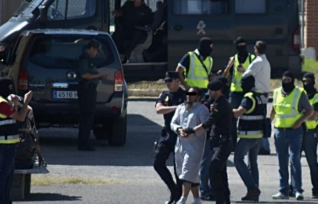 Spanish security forces escort an arrested suspected member of a jihadist cell onto a military aircraft in Spain's north African territory of Melilla on May 30, 2014 following pre-dawn raids, the government said. In a 4am (0200 GMT) operation, officers dismantled an international network that was recruiting and sending out jihadists to join "terrorist organisations" based in Mali and Libya, the Spanish interior ministry said in a statement. AFP PHOTO / BLASCO DE AVELLANEDA (Photo credit should read BLASCO DE AVELLANEDA/AFP/Getty Images)